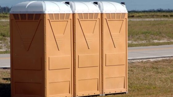 porta potty in a camping setting surrounded by nature