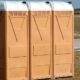 porta potty in a camping setting surrounded by nature