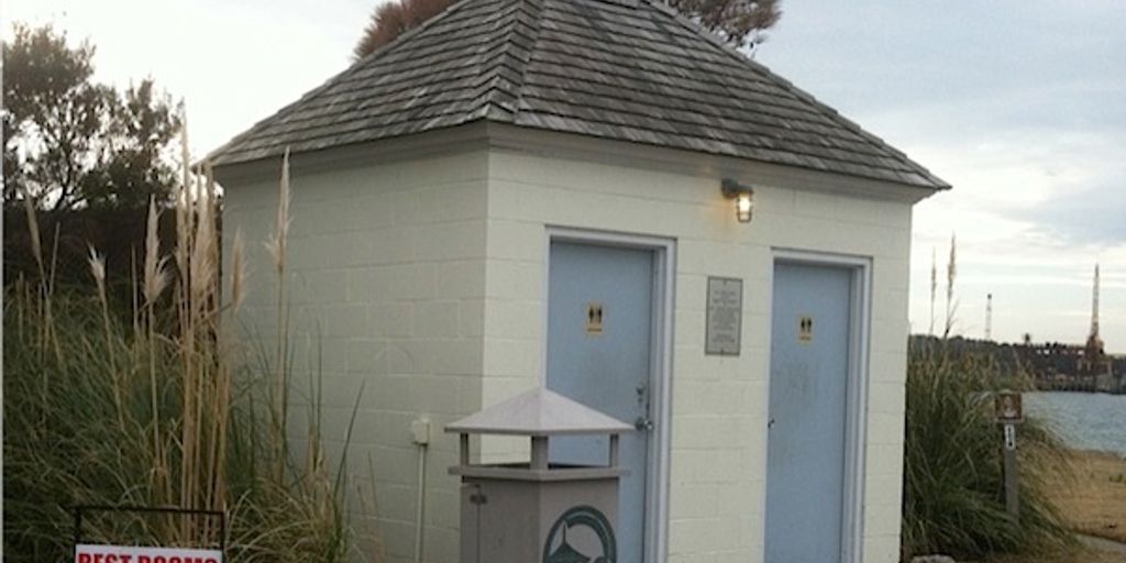 porta potty in a camping setting surrounded by nature