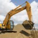 construction site workers wearing safety gear cleaning and sanitizing