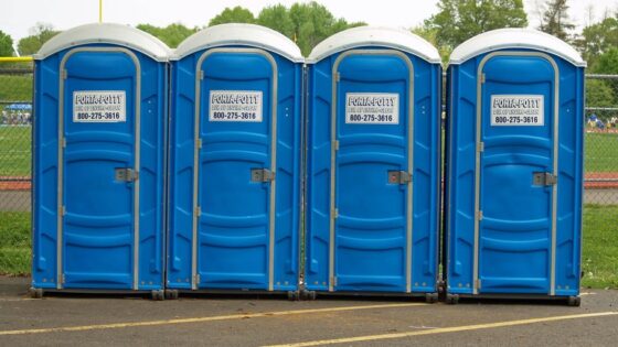 cleaning porta potty in a park