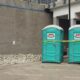 cleaning porta potty in outdoor event