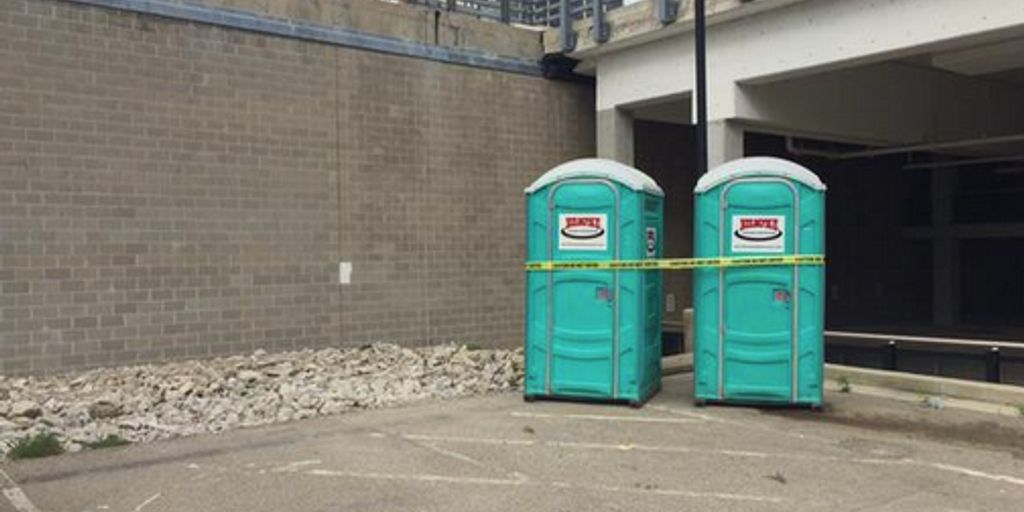 cleaning porta potty in outdoor event