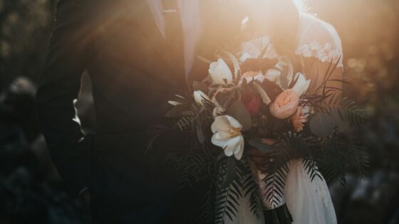 groom beside bride holding bouquet flowers