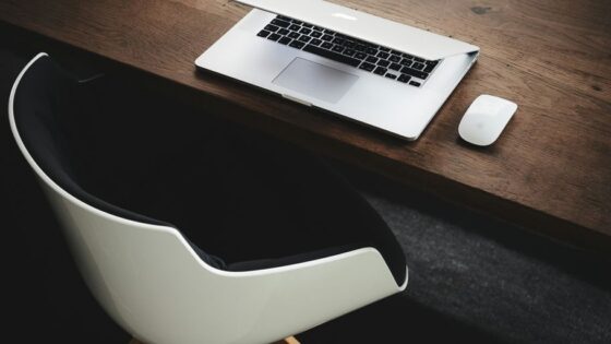 Apple MacBook beside computer mouse on table