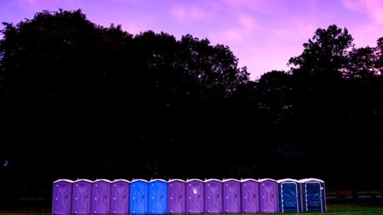 photography of portable toilet on field