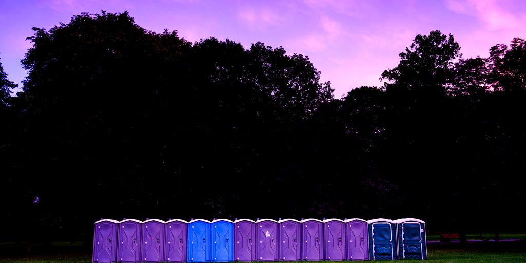 photography of portable toilet on field