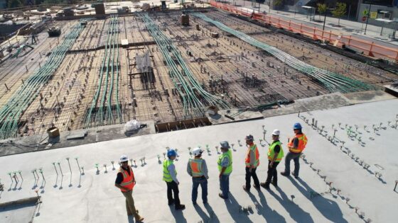 seven construction workers standing on white field