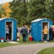 Outdoor party with porta potty in background