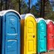 Colorful porta potties in an outdoor setting.